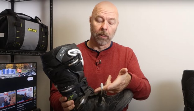 Rider showing the metal buckles and replaceable parts on a Tech 7 motocross boot