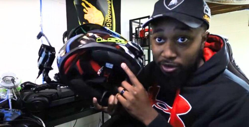 Rider pointing at the interior of an LS2 Rapid helmet while explaining padding and speaker fit issues