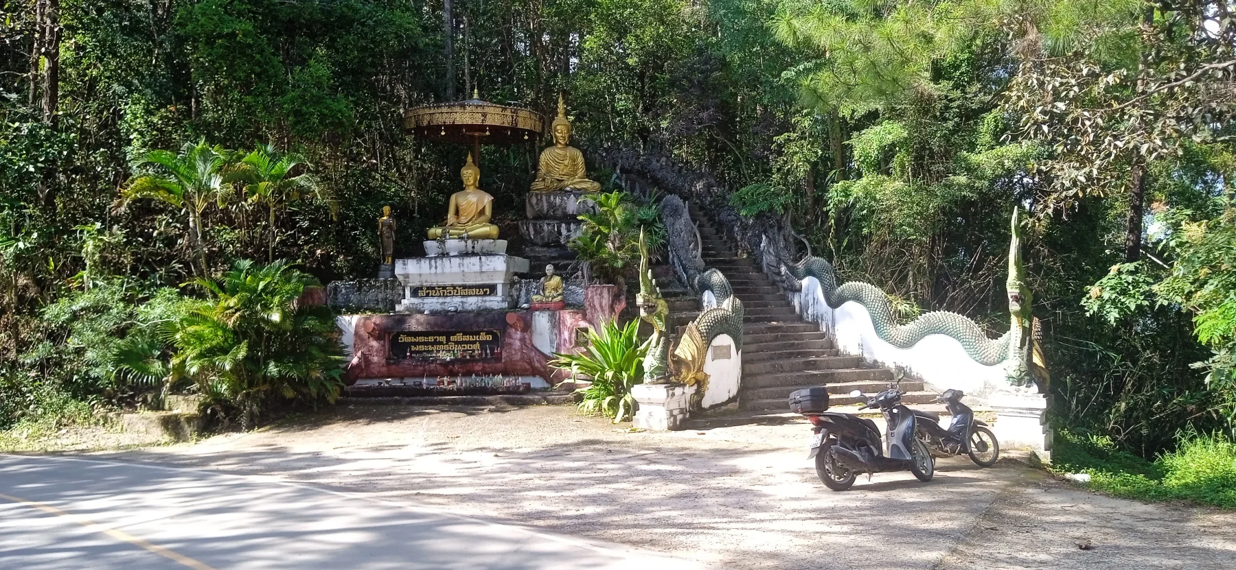 go up the steps about 400 meters to Wat Phra That Si Somdet Big Buddha Statue