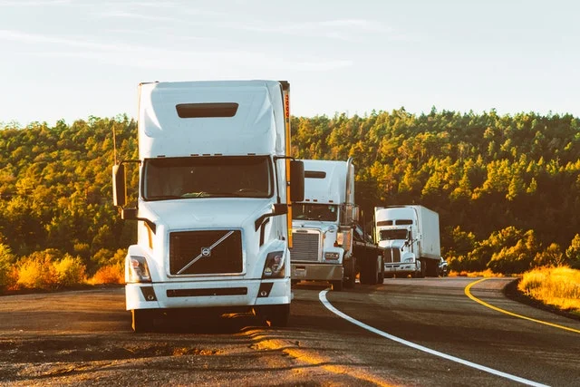 Semi trucks on the shoulder of the road