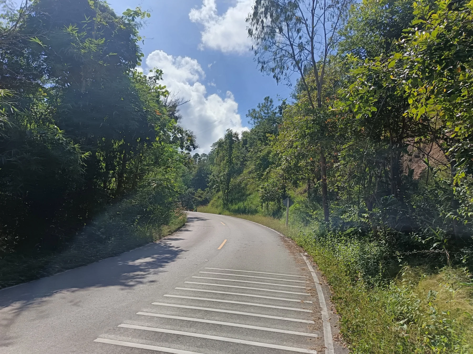 The perfect asphalt road now winds up a hill